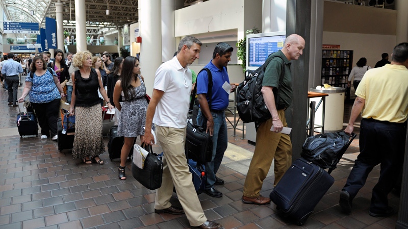 Travelers wait in line to board Amtrak's Northeast Regional train to Boston at Union Station in Washington, Friday, Aug. 26, 2011. (AP / Cliff Owen)