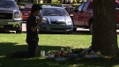 A mourner pays tribute to Valerie Leblanc at a memorial outside her school Friday, Aug. 26, 2011.