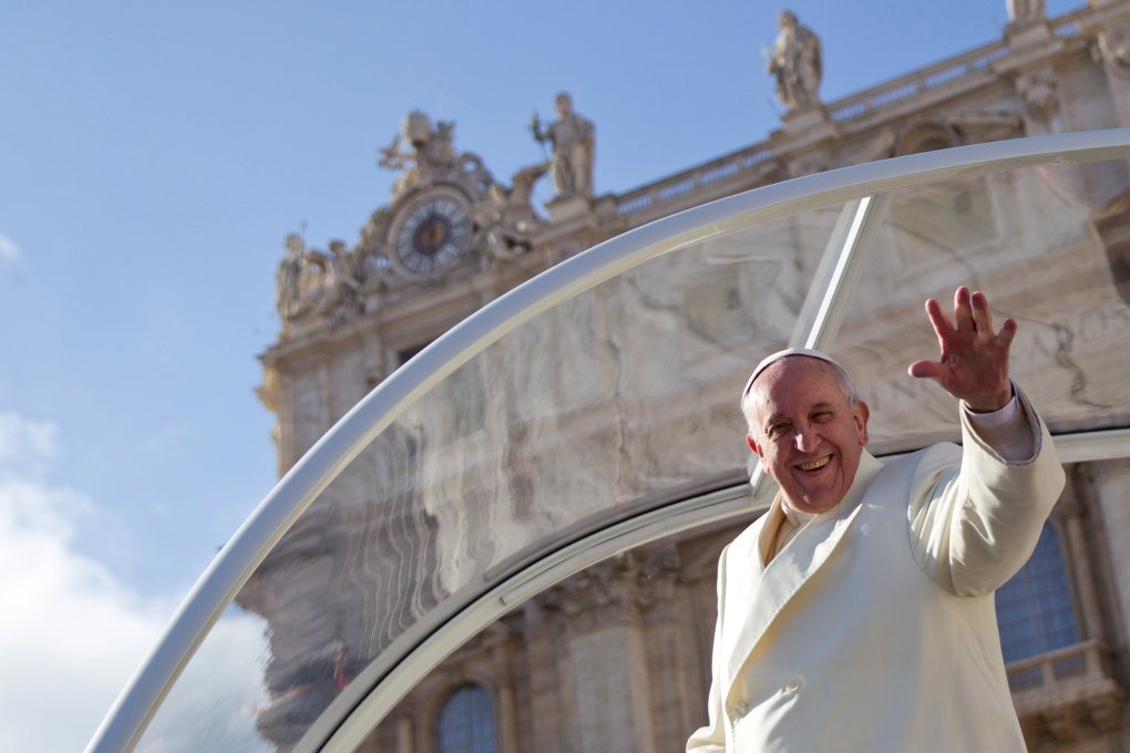 Pope Francis waves to the public at the Vatican