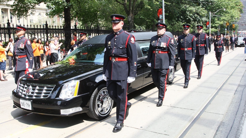 The funeral procession for the late NDP leader Jack Layton leaves City hall for Roy Thomson Hall, in Toronto on Saturday, Aug. 27, 2011. (Ryan Remiorz / THE CANADIAN PRESS)
