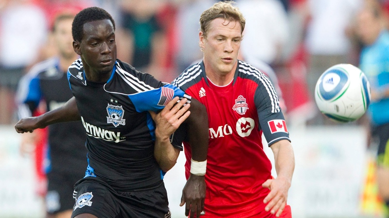 Toronto FC's Ty Harden, right, and San Jose Earthquakes' Simon Dawkins battle for the ball during the first half of a MLS soccer match in Toronto Saturday, August 27, 2011. THE CANADIAN PRESS/Darren Calabrese