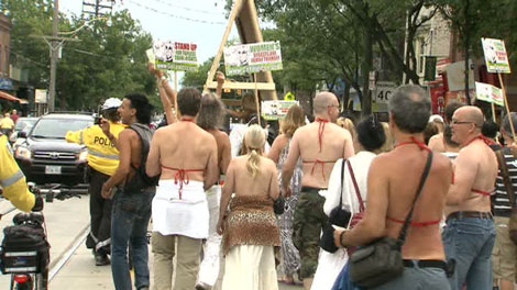 Traffic came to a halt Saturday afternoon as protestors marched the street topless after city officials denied them a special event permit to rally at a public park.