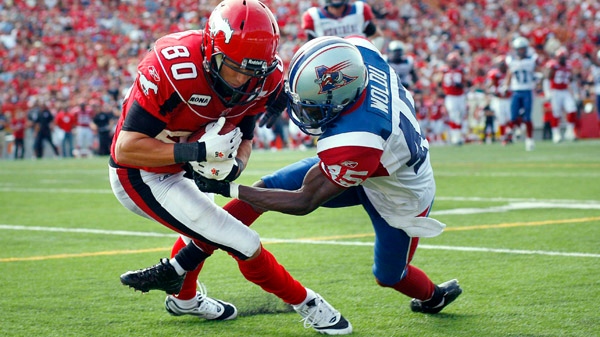Montreal Alouettes Paul Woldu, right, tries to stop Calgary Stampeders Johnny Forzani from making touchdown during second half CFL football action in Calgary, Alta., Saturday, Aug. 27, 2011. THE CANADIAN PRESS/Jeff McIntosh