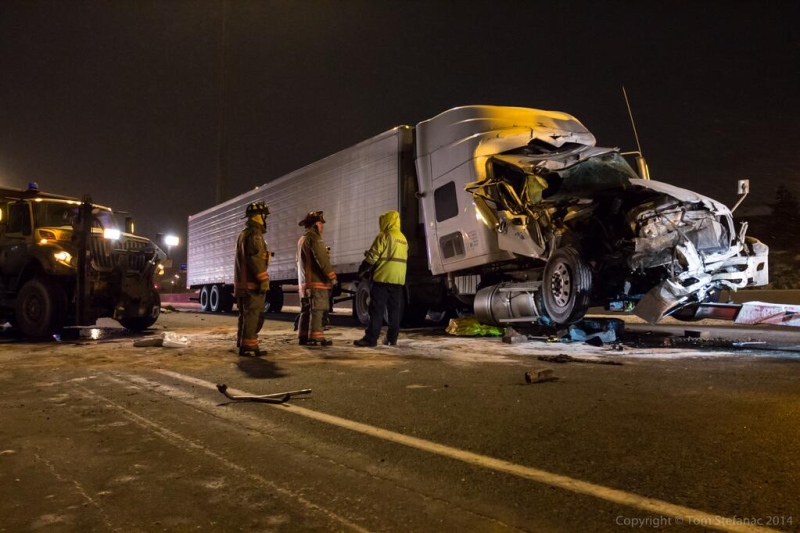 Firefighters attend the scene of a crash in Highway 401's westbound express lanes, near Morningside Avenue, early Thursday, Jan. 23, 2014. (Tom Stefanac/CP24)