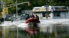 Members of Paterson Fire Department's Marine 3, patrol the intersection of Memorial Drive and Governor Road as the swollen Passaic River floods in Paterson, N.J., Wednesday, Aug. 31, 2011. (AP / Rich Schultz)