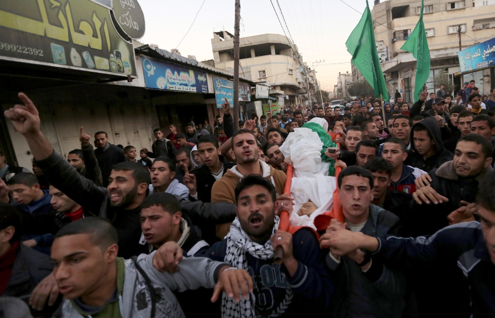 Mourners carry the body of Awidia on Gaza Strip