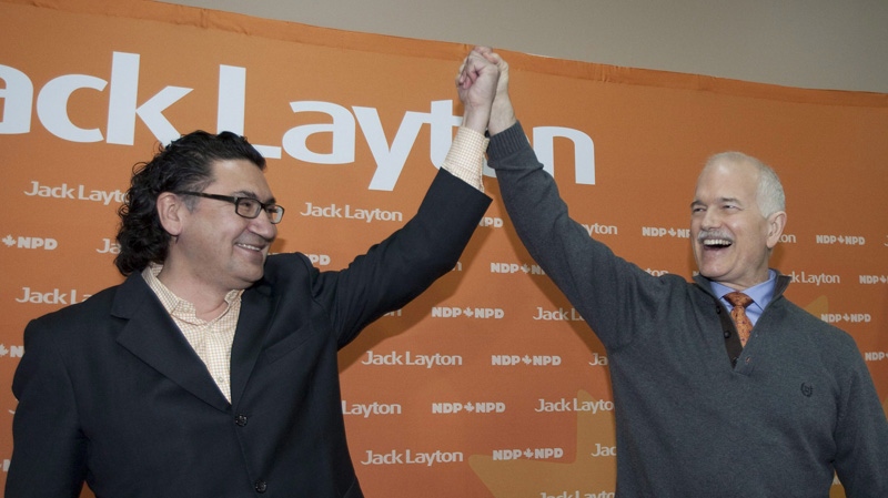 NDP Leader Jack Layton, right, raises the hand of candidate Romeo Saganash at a rally Monday, April 18, 2011 in Val d'Or, Que. THE CANADIAN PRESS/Jacques Boissinot