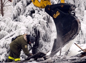 Emergency workers search for victims in L'Isle Verte, Que., at the scene of a fatal fire at a seniors' residence on Jan, 22, 2014. (CP / Ryan Remiorz)