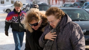 People arrive for a commemorative service for victims of last week's fatal fire at a seniors residence in L'Isle-Verte, Que. on Sunday, January 26, 2014. (Ryan Remiorz / THE CANADIAN PRESS)