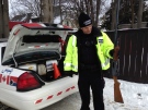 A London police officer holds a shotgun recovered after an alleged home invasion in London, Ont. on Wednesday, Jan. 29, 2014. (Chuck Dickson / CTV London)