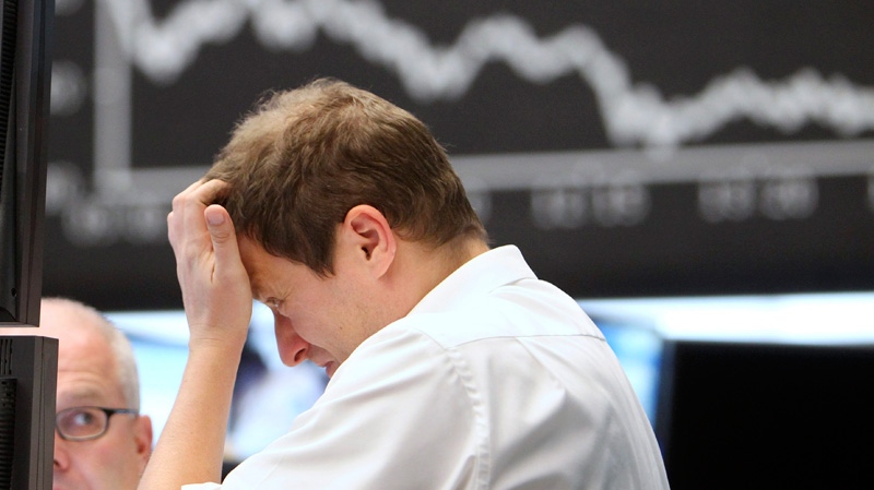 A trader scratches his head at the stock market in Frankfurt, Germany, Monday, Sept. 5, 2011. (AP / Michael Probst)