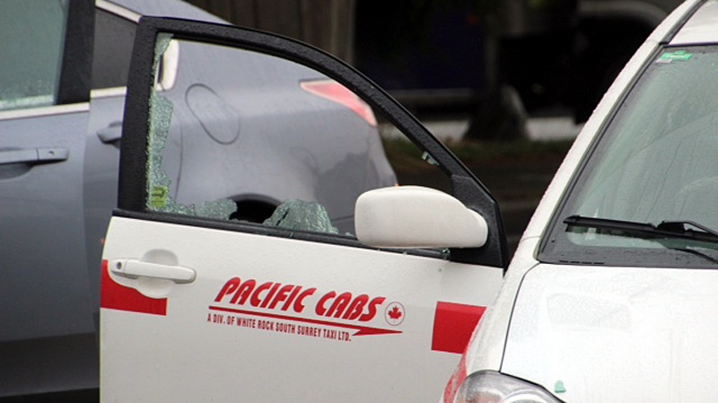 A shattered window can be seen on a Pacific Cabs taxi following an RCMP-involved shooting in White Rock, Wed., Jan. 29, 2014. (CTV)
