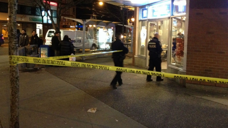 Vancouver police tape off an area in front of a Blenz Coffee on the corner of Commercial Drive and Broadway after finding a man with stab wounds there Friday, Jan. 31, 2014. (CTV)
