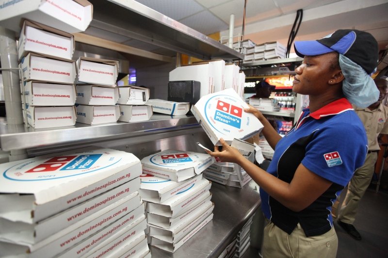 A worker prepares boxes at a Domino's pizza restaurant in Lagos, Nigeria on Sunday, Feb. 10, 2013. ( AP / Sunday Alamba)