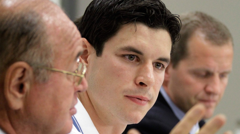 Pittsburgh Penguins' Sidney Crosby, center, and Dr. Michael Collins, right, listen as Dr. Ted Carrick, left, describes Crosby's progress in his recovery from a concussion he suffered in January 2011 during an NHL hockey news conference in Pittsburgh on Wednesday, Sept. 7, 2011. (AP / Gene J. Puskar)