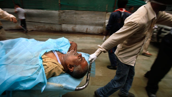 A man injured in a bomb blast is taken on a stretcher at the RML hospital in New Delhi, India, Wednesday, Sept. 7, 2011. (AP / Gurinder Osan)