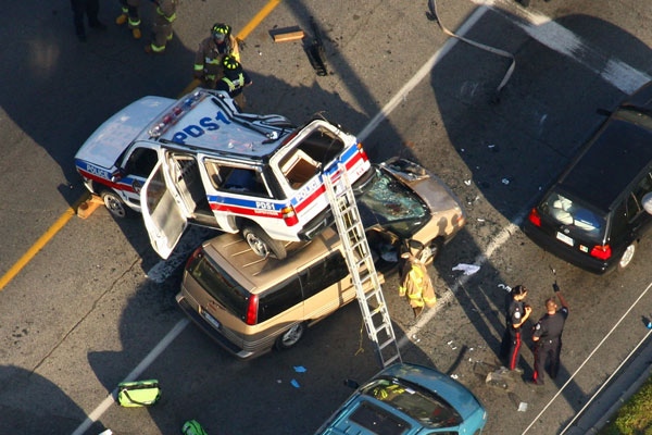 A police vehicle ended up on top of a van after a collision with a third vehicle on Victoria Park Ave. in Toronto, Tuesday, July 15, 2008. (Tom Podolec for CTV.ca)