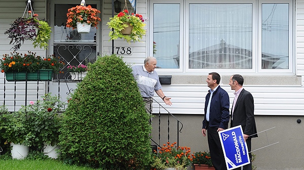 Progressive Conservative leader Tim Hudak makes a campaign stop the riding of Ottawa-South which is held by Liberal leader Dalton McGuinty in Ottawa on Thursday, September 8, 2011. Hudak, middle, knocks on the door of Heinz Osuch, left, along with PC candidate Jason MacDonald. (THE CANADIAN PRESS/Sean Kilpatrick)