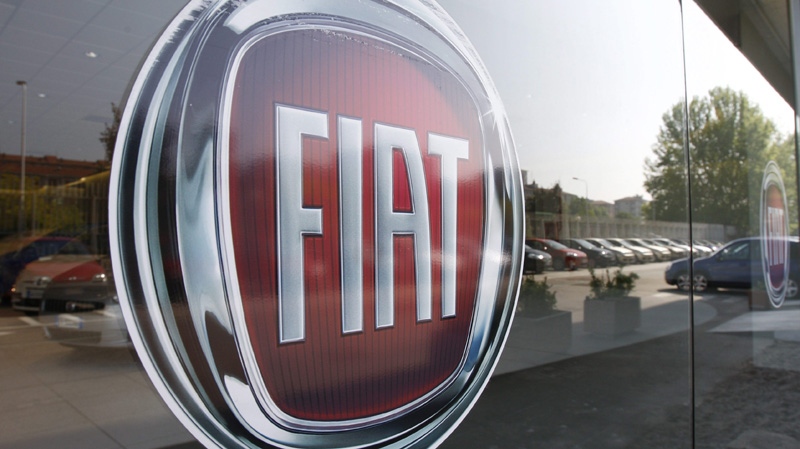 In this May 7, 2009 file photo, a Fiat logo is seen on a car retailer's window in Milan, Italy. (AP Photo/Luca Bruno, File)
