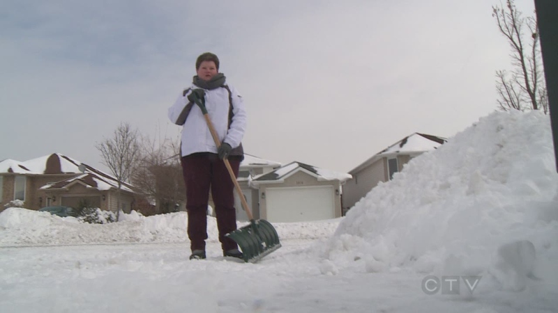 Carolyn Stanzel can be seen shoveling  her driveway in South Windsor on Jan. 6. (CTV Windsor)