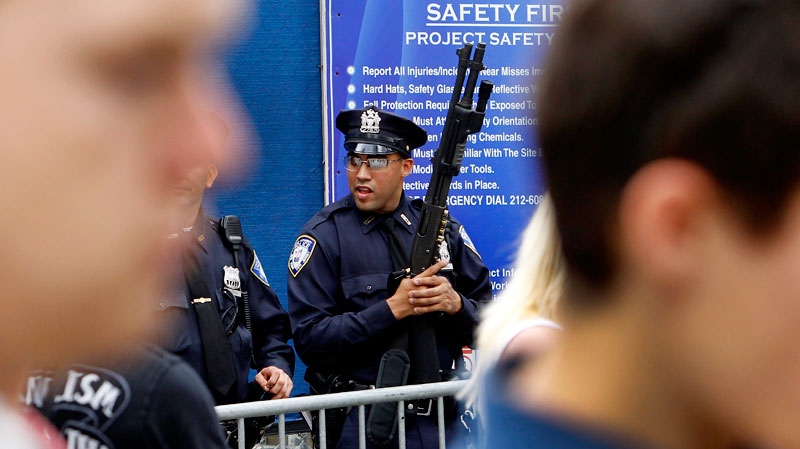 New York City police stand guard at the entrance to the World Trade Center site, as officials tighten security as they prepare for the 10th anniversary of the 9-11 attacks, Saturday, Sept. 10, 2011, in New York. (AP / The Dallas Morning News, Louis DeLuca)
