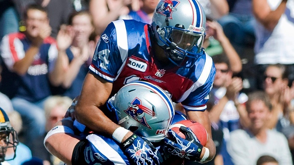 Montreal Alouettes' Brandon London and Luc Brodeur-Jourdain (58) celebrate a touchdown during first half CFL football action against the Hamilton Tiger-Cats in Montreal, Sunday, Sept., 11, 2011. THE CANADIAN PRESS/Graham Hughes