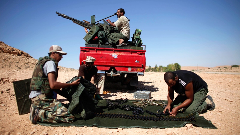 Former rebel fighters prepare an anti-aircraft weapon near the entrance of Bani Walid, Libya, Sunday, Sept. 11, 2011. (AP / Alexandre Meneghini)