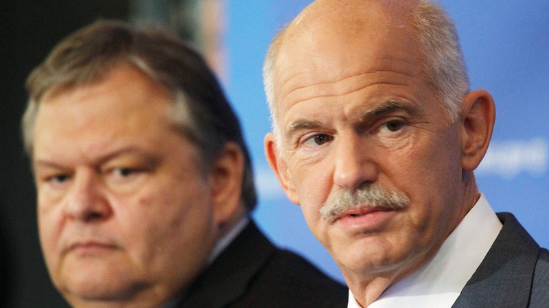 Greek Prime Minister George Papandreou, right, backed by his Finance Minister Evangelos Venizelos talks to the media during a press conference in Thessaloniki, Greece on Sunday, Sept. 11, 2011. (AP / Dimitri Messinis)