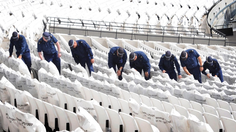 Police officers take part in a search exercise at the Olympic Stadium in London on June 19, 2011. (Stefan Rousseau / PA)