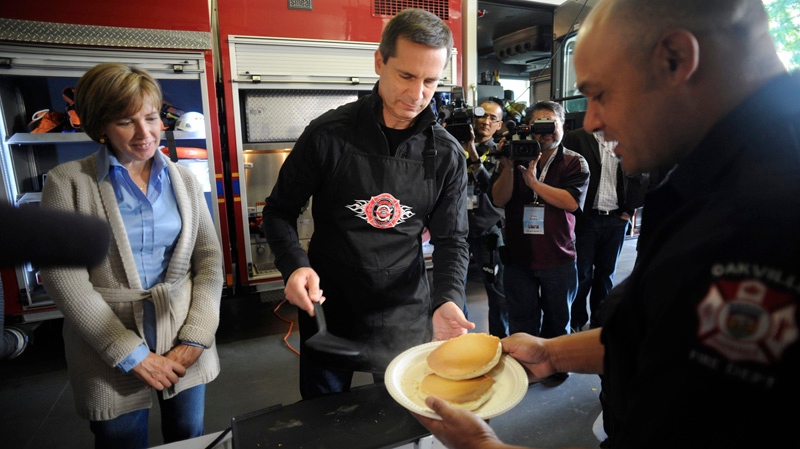 Terri McGuinty, left, and her husband, Ontario Premier Dalton McGuinty prepares pancakes for Oakville firefighters during a pancake breakfast, in Oakville, Ontario, Sunday September 11, 2011. THE CANADIAN PRESS/Ian Willms