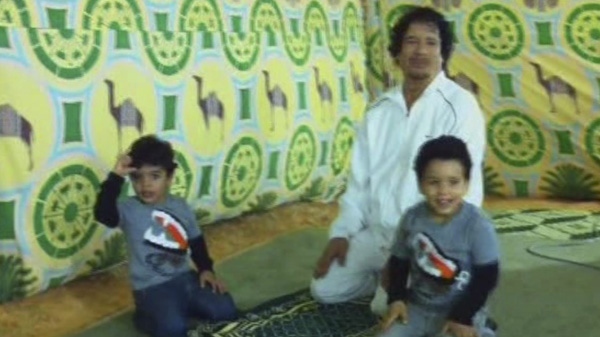 An image from an undated 32-second video, obtained Monday Sept 12 2011 by The Associated Press, which was found on a laptop in the home of Gadhafi's son Hannibal, showing Moammar Gadhafi clowning around with two young boys, presumably his grandsons, at an unknown location. (AP Photo)