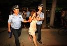 Policemen detain suspected prostitutes in a campaign to crack down on prostitution in Xi'an, in northwestern China's Shaanxi province on Aug. 13, 2010. (AP Photo) 