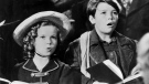 This photo released by Daniel Watson shows his uncle Delmar Watson, right, as Peter with Shirley Temple as Heidi in a scene from the 1937 film 'Heidi.'  Watson, a child actor who appeared in hundreds of movies and later became a photographer, died at his Glendale, Calif., home Sunday, Oct. 26, 2008, from complications of prostate cancer. He was 82. (AP / Courtesy of Delmar Watson's family