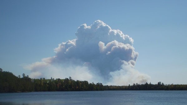 This photo provided by Visit Duluth Public Relations, smoke fills the sky from a fire outside the borders of the Boundary Waters Canoe Area near Ely, Min. on Sept. 11, 2011. The Pagami Creek forest fire has more than tripled in size since Sunday and has grown to cover more than 16,000 acres. The blaze has forced Lake County and Superior National Forest officials to close several county and Forest Service roads north of Minnesota Highway 1 between Ely and Isabella. Some residents and campers are being asked to evacuate the area. (AP Photo/Visit Duluth Public Relations, Gene Shaw) 