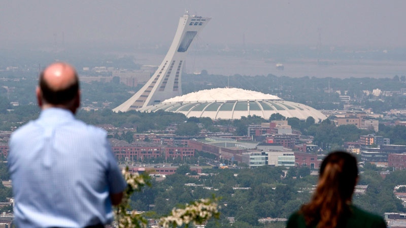 Tourists check out Olympic Stadium in Montreal on May 31, 2010. (Paul Chiasson / THE CANADIAN PRESS)
