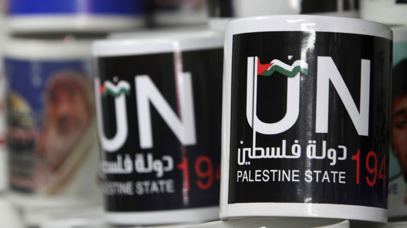 Cups designed as part of the campaign promoting the Palestinians' bid for statehood are displayed in a souvenirs shop in Gaza City, Tuesday, Sept. 13, 2011. (AP Photo/Adel Hana)