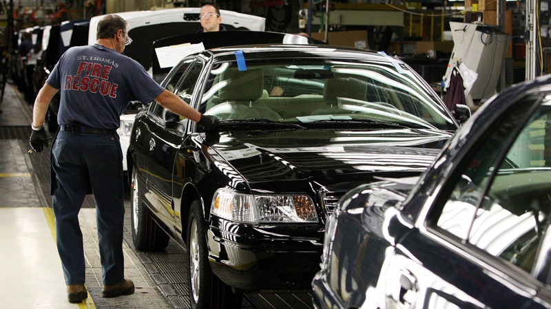 Factory employees work on Ford Crown Victoria vehicles on Sept. 8, 2011 at the Ford Assembly Plant in St. Thomas, Ont. (Dave Chidley / THE CANADIAN PRESS)