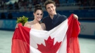 Ice dance silver medallists Canada's Tessa Virtue and Scott Moir pose with the Canadian flag during flowers ceremony at the Sochi Winter Olympics Monday, Feb, 17, 2014 in Sochi. (Paul Chiasson / THE CANADIAN PRESS)