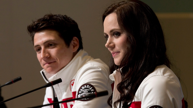 Canada's Scott Moir and Tessa Virtue listen to a question during a news conference at the Sochi Winter Olympics Tuesday, Feb. 18, 2014. (Adrian Wyld / THE CANADIAN PRESS)