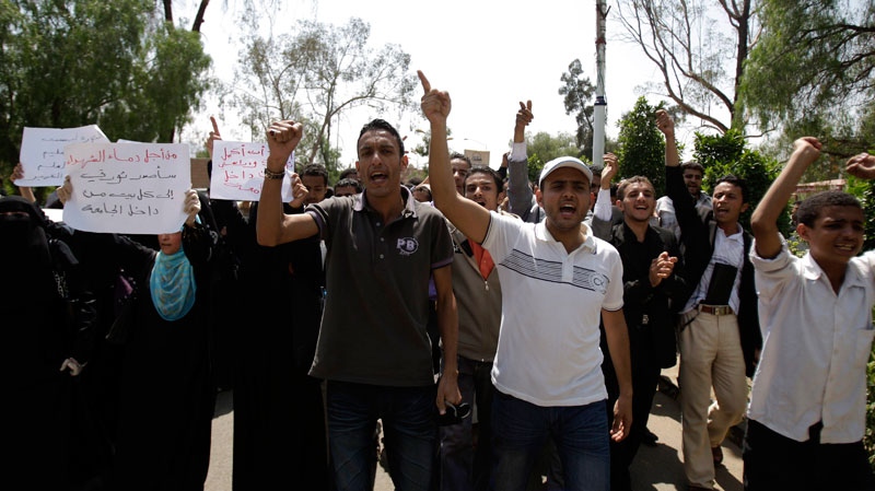 Students shout slogans as they protest on the Sanaa University campus to show their support for a boycott of university studies as part of protests demanding the resignation of Yemeni President Ali Abdullah Saleh, in Sanaa,Yemen, Sunday, Sept. 18, 2011. (AP / Hani Mohammed)
