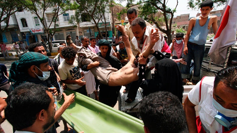 Anti-government protesters carry a wounded protester from the site of clashes with security forces, in Taiz, Yemen, Monday, Sept. 19, 2011. (AP / Anees Mahyoub)