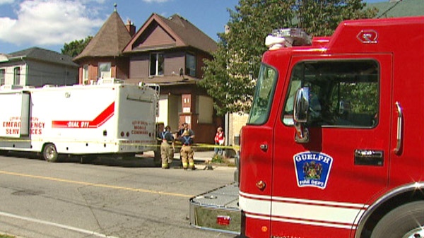 Firefighters are seen at the scene of a fire at a rooming house in Guelph, Ont. on Sunday, Sept. 18, 2011.