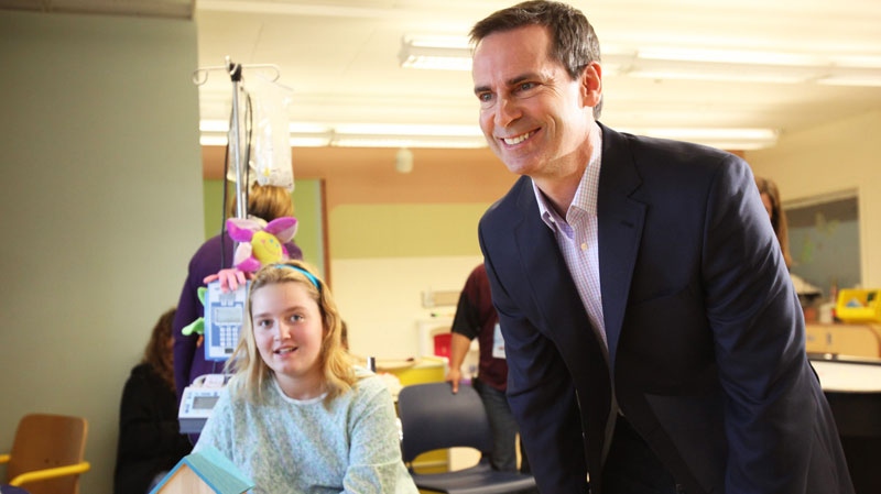 Ontario Premier Dalton McGuinty talks with patients and 14-year old Katie Hopper during a campaign stop at the Children's Hospital of Eastern Ontario in Ottawa on Monday, Sept. 19, 2011. THE CANADIAN PRESS/ Patrick Doyle