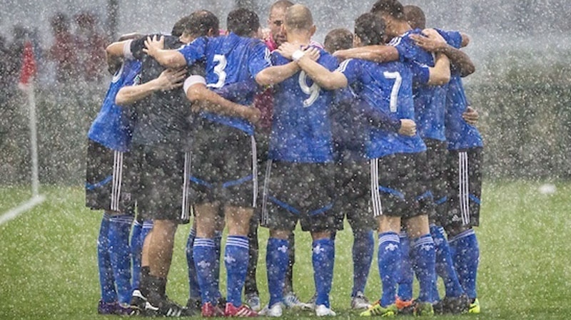 The Impact are seen huddling in the rain in Orland