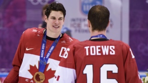 Men's hockey gold medallist Sidney Crosby celebrates with teammate Jonathan Toews after beating Sweden 3-0 in the final at the Sochi Winter Olympics Sunday, February 23, 2014 in Sochi. THE CANADIAN PRESS/Paul Chiasson