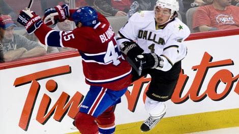 Montreal Canadiens' Michael Blunden (45) collides with Dallas Stars' Brenden Dillon (4) during third period pre-season NHL hockey action in Montreal, Tuesday, Sept., 20, 2011. THE CANADIAN PRESS/Graham Hughes