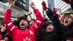 Hockey fans celebrate in Toronto's Maple Leaf Square after the final buzzer as Canada beat Sweden 3-0 to win the Gold Medal in the men's Olympic Hockey Final on Sunday, Feb. 23, 2014. (Chris Young / THE CANADIAN PRESS)