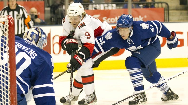 Toronto Maple Leafs Jake Gardiner (right) breaks up the play as Ottawa Senators Milan Michalek (9) closes in on goaltender Ben Scrivens during third period NHL pre-season action in Toronto on Monday September 19, 2011. 