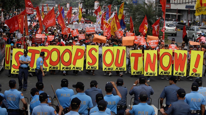 Riot police, protesters in Manila, Philippines