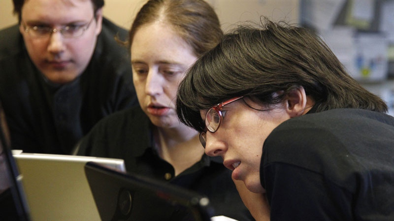 In this photo taken Thursday, Sept. 8, 2011, Aspiritech employees, from left, Rick Alexander, Katie Levin, and Jamie Specht work together at the nonprofit enterprise that specializes in finding software bugs as they test a new program in Highland Park, Ill. (AP Photo/M. Spencer Green)
